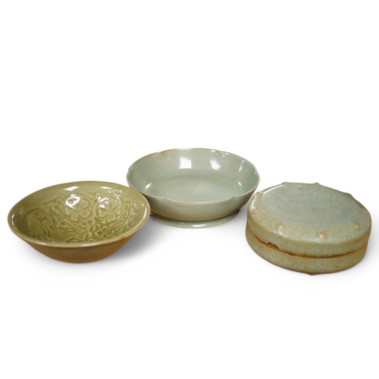 A Chinese celadon glazed box and cover and two similar bowls, largest 15cm diameter. Condition - varies